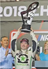  ?? AP PHOTO/TERRY RENNA ?? Tyler Reddick holds the trophy after winning the NASCAR Xfinity Series championsh­ip race at Homestead-Miami Speedway on Saturday.