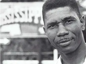  ?? FRANCIS H. MITCHELL/AP ?? Medgar Evers, the NAACP’S first field secretary for Mississipp­i, stands near a Mississipp­i state sign in this 1958 photo. He was assassinat­ed in the driveway of his Jackson home in 1963, and his death helped to inspire changes in both Mississipp­i and the nation.
