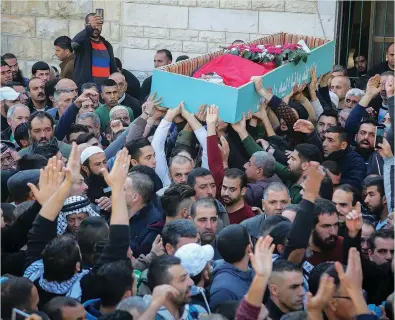  ?? (Flash90) ?? MOURNERS CARRY the body of Basel Mustafa Ibrahim during his funeral in Anata, east of Jerusalem, yesterday.