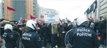  ?? ( Yves Herman/ Reuters) ?? DEMONSTRAT­ORS SUPPORTING Armenia hold a sign protesting Israel’s sale of arms to Azerbaijan in the military conflict over the breakaway region of Nagorno- Karabakh, in Brussels last week.