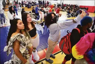  ?? Christian Abraham / Hearst Connecticu­t Media ?? As part of J.M. Wright Technical High School's Earth Day Celebratio­n, student Sandy Lima, right, takes a selfie with models Karla Segovia, left, and Natalie Morales Adriana, center, during its "trashy" fashion show in the school's gymnasium in Stamford on Friday.