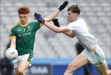  ??  ?? St. Peter’s midfielder Brian Deeny tries to make life difficult for Niall Donohue of St. Brendan’s.