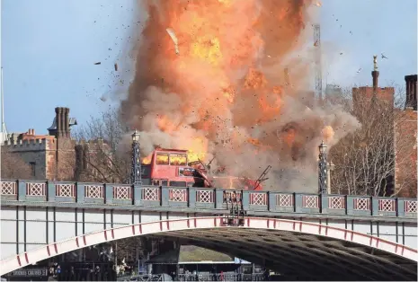  ?? STEVE PARSONS, PA WIRE ?? Filmmakers exploded a real bus on Lambeth Bridge near the Houses of Parliament in London in February 2016.