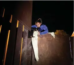  ??  ?? A migrant, part of a caravan of thousands from Central America trying to reach the United States, tries to jump a border fence to cross illegally from Mexico to the US, in Tijuana, Mexico. — Reuters photo