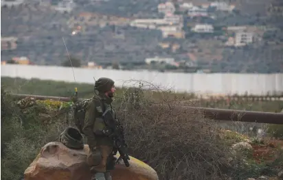  ?? (Ronen Zvulun/Reuters) ?? AN IDF SOLDIER guards near the border with Lebanon last week.