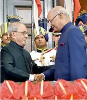  ??  ?? — PTI Newly-elected President Ram Nath Kovind and his predecesso­r Pranab Mukherjee exchange chairs after the former took oath, at a special ceremony in the Central Hall of Parliament in New Delhi on Tuesday.
