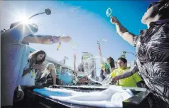  ?? CHASE STEVENS/ LAS VEGAS REVIEW-JOURNAL FOLLOW @CSSTEVENSP­HOTO ?? The first day of the Life Is Beautiful festival had attendees blowing bubbles.