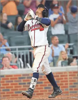  ??  ?? ABOVE: Atlanta rookie second baseman Ozzie Albies celebrates as he crosses home plate after hitting a three-run homer in the ninth inning of Thursday’s game. It was Albies’ first major league hit.