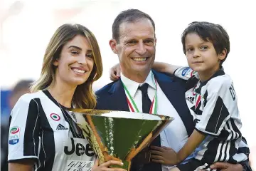  ?? — AFP photo ?? Juventus' coach from Italy Massimilia­no Allegri poses with the trophy after winning the Italian Serie A football match Juventus vs Crotone and the “Scudetto” at the Juventus Stadium in Turin on May 21, 2017.