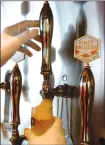  ?? Associated Press photo ?? A server pours a beer into a glass at a beer restaurant Spring Valley Brewery in Tokyo.