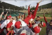  ?? MATT SLOCUM ?? FILE - In this Aug. 12, 2017, file photo, Japan players throw their coach, Manasori Takeda, into the air after winning the Little League World Series Championsh­ip baseball game against Lufkin, Texas, in South Williamspo­rt, Pa. Millions of people locked down in their homes makes it increasing­ly unlikely that the Little League World Series will carry on as planned in 2020.