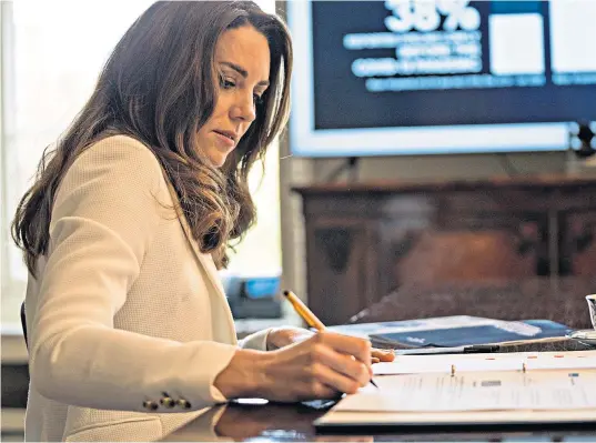  ??  ?? The Duchess takes notes during a video call with Kelly Beaver, public affairs managing director at Ipsos MORI, ahead of her speech at a Royal Foundation forum