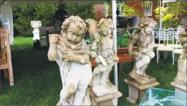  ?? Noel Ambery / Hearst Connecticu­t Media ?? Stone garden cherubs stood outside the tent for Pillars Antiques of Freeport, Maine, one of 60 vendors this year at the 18th annual Trade Secrets Rare Plant and Garden Antiques Sale held at LionRock Farm, a 600-acre farm at 30 Hosier Road in Sharon.