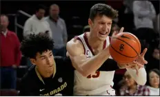  ?? ASHLEY LANDIS — THE ASSOCIATED PRESS ?? Colorado guard KJ Simpson, left, will be one of several Buffs players aiming to slow USC’S Drew Peterson when the teams collide at CU Events Center.