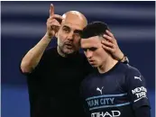  ?? AFP ?? Manchester City manager Pep Guardiola with Phil Foden after the semifinal defeat against Real Madrid