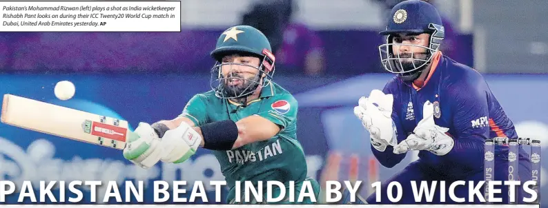  ?? AP ?? Pakistan’s Mohammad Rizwan (left) plays a shot as India wicketkeep­er Rishabh Pant looks on during their ICC Twenty20 World Cup match in Dubai, United Arab Emirates yesterday.