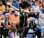  ?? Sarah Gordon/Associated Press ?? The Connecticu­t Sun’s DiJonai Carrington (21) has a shot blocked by the New York Liberty’s Breanna Stewart during the first half on Tuesday at Mohegan Sun Arena in Uncasville.