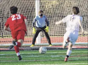  ?? Jenn March / Jenn March Photograph­y ?? Stillwater goalie Evan Coe anticipate­s action as Mechanicvi­lle’s Tyler Tesoriero charges downfield trailed by Stillwater defender Ryan Henderson.