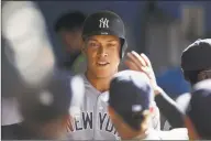  ?? Cole Burston / Getty Images ?? The Yankees’ Aaron Judge celebrates in the dugout after scoring on a Luke Voit double in the third inning against the Blue Jays on Saturday.