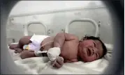  ?? GHAITH ALSAYED — THE ASSOCIATED PRESS ?? A baby girl who was born under the rubble caused by an earthquake receives treatment inside an incubator at a children's hospital in Syria on Feb. 7.