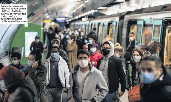  ??  ?? Commuters wearing face masks walk on the platform of a Paris subway as they are told their country is currently losing the battle against the virus