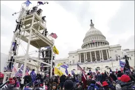  ?? JOHN MINCHILLO — THE ASSOCIATED PRESS FILE ?? Violent insurrecti­onists loyal to President Donald Trump breach the U.S. Capitol in Washington on Jan. 6, 2021.