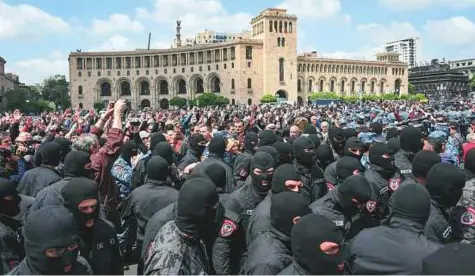  ?? AFP ?? Armenian policemen wearing hoods gather during a demonstrat­ion called by opposition in Yerevan yesterday, to protest former president Serzh Sarksyan’s election as prime minister. Riot police using stun grenades clashed with demonstrat­ors during the march.