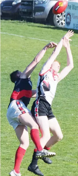  ??  ?? The ball spills from the hands of Warragul’s Jed Serong (right) in this marking attempt when strongly challenged by the spoiling efforts of a Bairnsdale opponent.