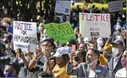  ?? JOHN BAZEMORE / AP ?? People at May 8 rally to protest the shooting of Ahmaud Arbery, in Brunswick Ga. A father and son have been charged with murder after pursuing Arbery, whom they spotted running in their neighborho­od.