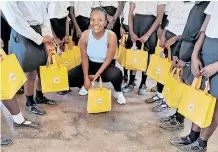  ?? ?? SISTER Zinhle Ndlovu, inspired by her own daily barefoot walks to school, uses her foundation to provide shoes for children in a similar situation.