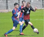  ??  ?? A St Murdoch’s player (black) weaves his way out of a challenge in the win over Monifieth Athletic.