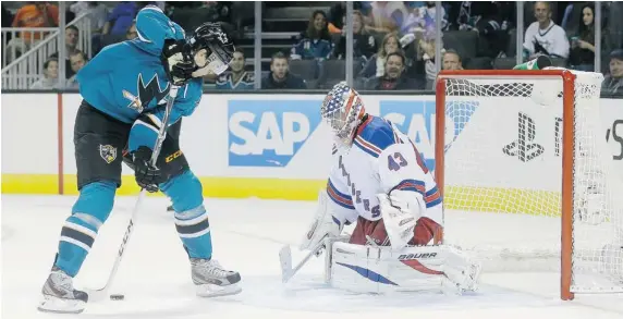  ?? MARCIO JOSE SANCHEZ/THE ASSOCIATED PRESS ?? Sharks centre Tomas Hertl, left, beats New York Rangers goalie Martin Biron for his fourth goal of the game during the third period on Tuesday night in San Jose, Calif.