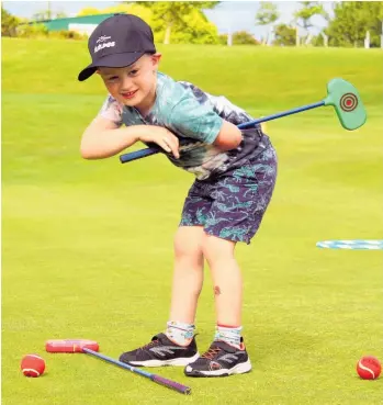  ?? Photo / Judith Lacy ?? Leon Ward, 5, checks on his shot at Parafed Manawatu¯ 's adaptive golf programme at Feilding Golf Club.