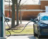  ?? HUH/AP ?? An electric vehicle gets charged at Woodfield Village Green in Schaumburg, Ill., on April 1. A wave of new charging stations is coming across the country.Nam Y.