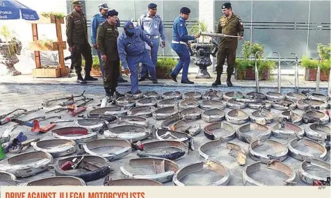  ?? APP ?? Parts of motorcycle­s, which were removed during a major operation against illegal motorcycli­sts on the eve of Independen­ce Day celebratio­ns, on display at the Traffic Police office in Saddar yesterday.