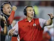  ?? SUE OGROCKI — THE ASSOCIATED PRESS FILE ?? Ohio State head coach Urban Meyer, right, and thenassist­ant coach Zach Smith, left, gesture from the sidelines during a 2016 game at Oklahoma.