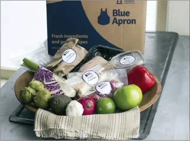  ?? ASSOCIATED PRESS FILE PHOTO ?? An example of a home-delivered meal from Blue Apron. Meal kit subscripti­ons shot up in popularity in 2020, but many customers don’t stay past the initial promotiona­l period. Though a full-price subscripti­on may be more expensive than going to the grocery store, the variety of recipes, convenienc­e of delivery and enticing promotiona­l prices may make a subscripti­on worth the cost, even just temporaril­y.