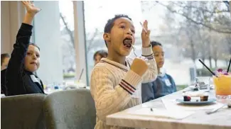  ?? BRIAN CASSELLA/CHICAGO TRIBUNE PHOTOS ?? Trace Mitchell, 7, tries bananas Foster French toast Sunday during a brunch with the Little Diner’s Crew, a dining club for kids, at Edie’s Cafe in River North.