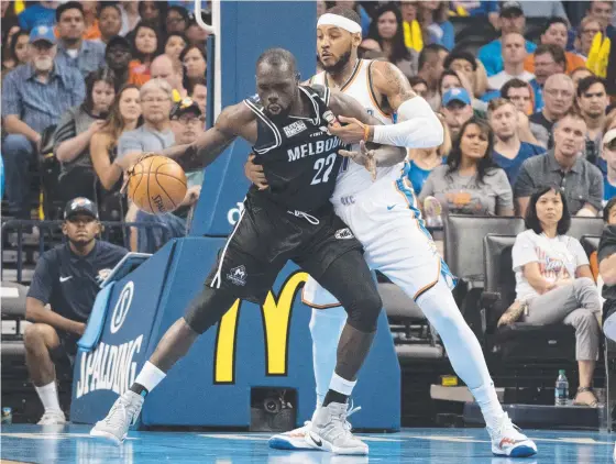  ?? DRAWCARD: Majok Majok of Melbourne United goes up against Oklahoma City Thunder’s Carmelo Anthony in an NBA/ NBL pre- season game in October. ??