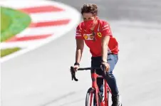  ?? — AFP photos ?? Ferrari’s Charles Leclerc inspects the track on his bicycle on the eve of the first practice session at the Austrian Formula One Grand Prix in Spielberg, Austria.