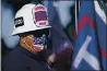  ?? ASHLEY LANDIS — THE ASSOCIATED PRESS ?? A man wearing a firefighte­r’s helmet attends a rally in support of President Donald Trump outside Thousand Oaks City Hall on Wednesday.