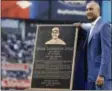  ?? KATHYWILLE­NS — THE ASSOCIATED PRESS ?? Retired New York Yankees shortstop Derek Jeter poses with the plaque that will be installed in Monument Park during a pregame ceremony retiring his number 2at Yankee Stadium in NewYork, Sunday.