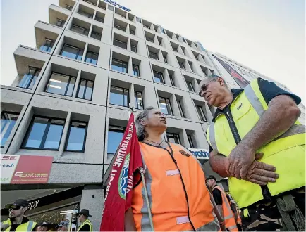  ?? PHOTOS: JOSEPH JOHNSON/STUFF ?? Port workers Polly Bysterveld and Laurie Collins protest outside the offices of the Christchur­ch City Council’s holding company.