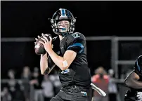  ??  ?? Lincoln-Way East’s Jack Baltz looks for a receiver on Friday. He completed 8 of 11passes for 157 yards and two TDs.