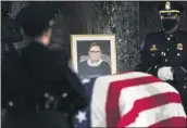  ?? ERIN SCHAFF — THE NEW YORK TIMES ?? The flag-draped casket of Justice Ruth Bader Ginsburg lies in state in the U.S. Capitol on Friday Ginsburg died at the age of 87 on Sept. 18 and is the first women to lie in state at the Capitol.