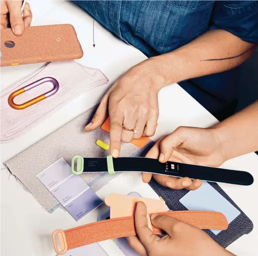  ??  ?? Google designers, who often draw inspiratio­n from everyday objects (including socks and carabiners), look at swatches for an unreleased wearable the team developed for the Milan Furniture Fair.