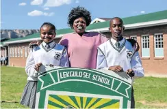  ?? Picture: Simphiwe Nkwali ?? Karabo Motaung, principal Mirriam Khanya and Thabang Mosia of Lekgulo Secondary School. The Free State village school has achieved a 100% matric pass rate for five years in a row. Mosia last year bagged seven distinctio­ns.