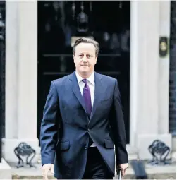  ?? LEFTERIS PITARAKIS/The Associated Press ?? British Prime Minister David Cameron faces a rebellion within his own ranks as he tries to stand up to his promises to the Scottish people to allow the Scot
tish Parliament to decide on their own issues.
