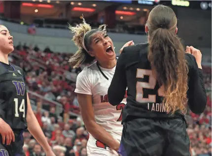  ?? ?? Louisville’s Nyla Harris celebrates getting fouled while trying to make a shot against Washington on Wednesday night at the KFC Yum! Center.