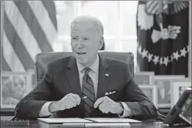  ?? AP-Evan Vucci ?? President Joe Biden signs a series of executive orders on health care, in the Oval Office of the White House, on Thursday in Washington.